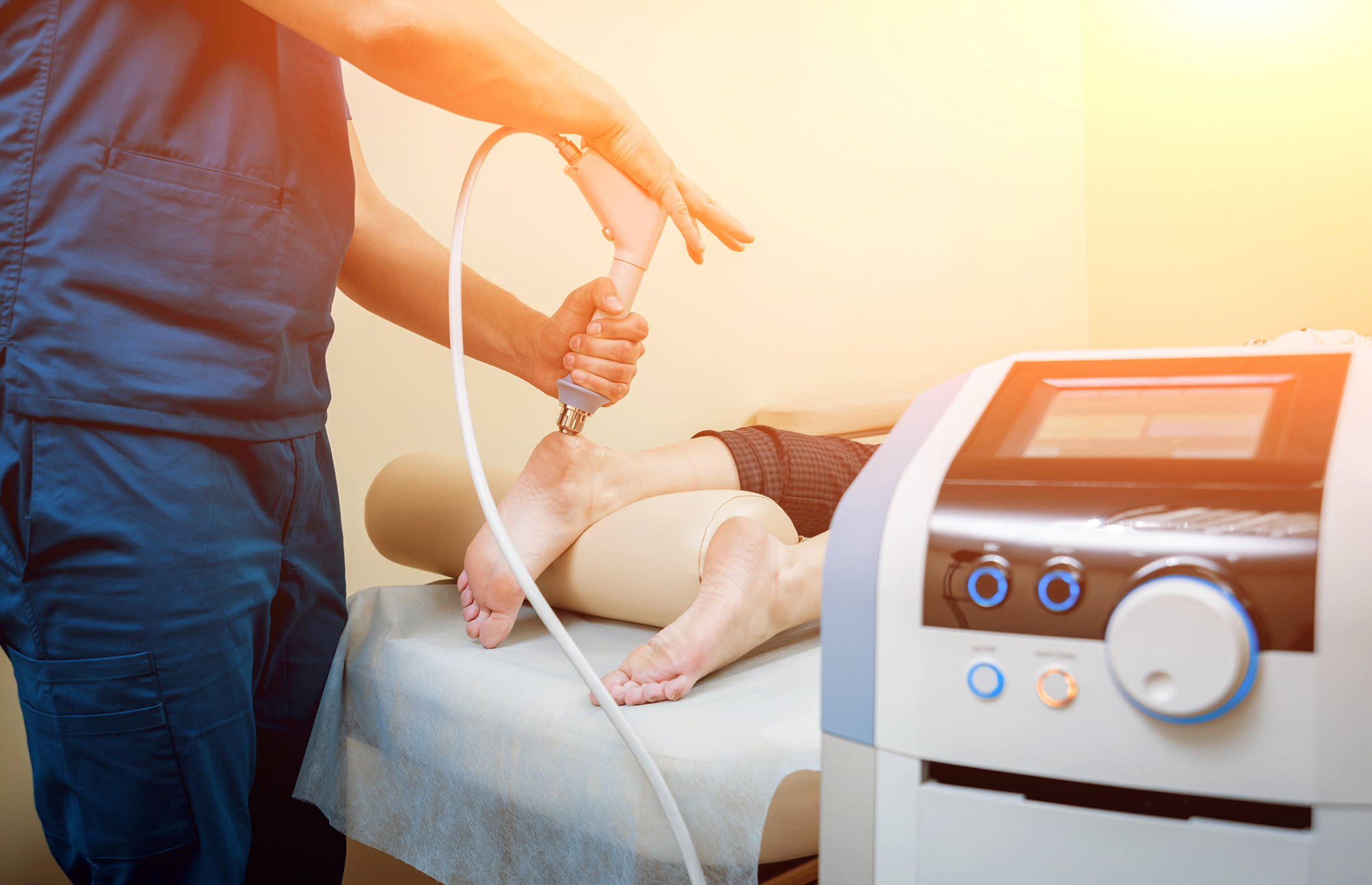 Shock wave therapy. The magnetic field, rehabilitation. Physiotherapist doctor performs surgery on a patient's heel